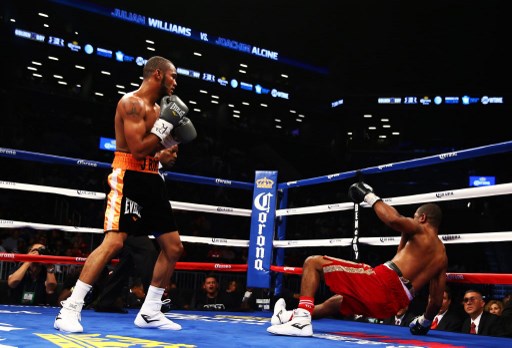 Julian Williams stands over his opponent Joachim Alcine who was just knocked down before competing in Saturday Night Fights On ESPN FOX event.