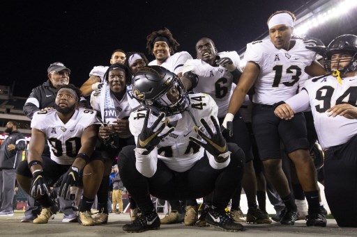 Team of UCF Knights posing for a picture during the game against Temple Owls