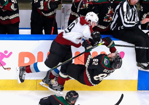 Colorado's MacKinnon knocks over an opponent. This series will be covered in our NHL Western Conference playoffs recap.