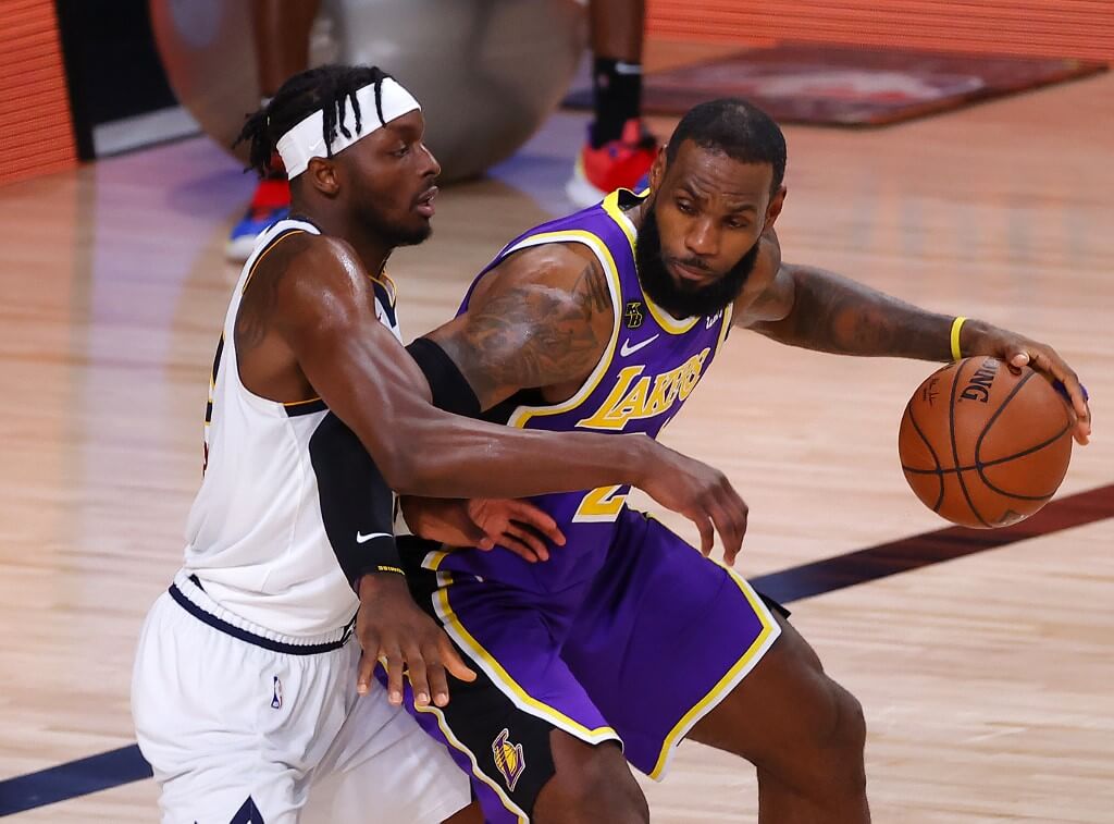 In this file photo taken on September 27, 2020 LeBron James of the Los Angeles Lakers drives the ball against Jerami Grant of the Denver Nuggets