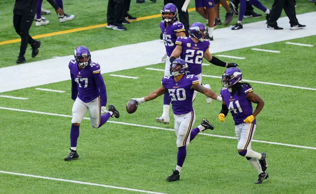 Eric Wilson of the Minnesota Vikings celebrates with teammates after he intercepted a pass thrown by Matthew Stafford