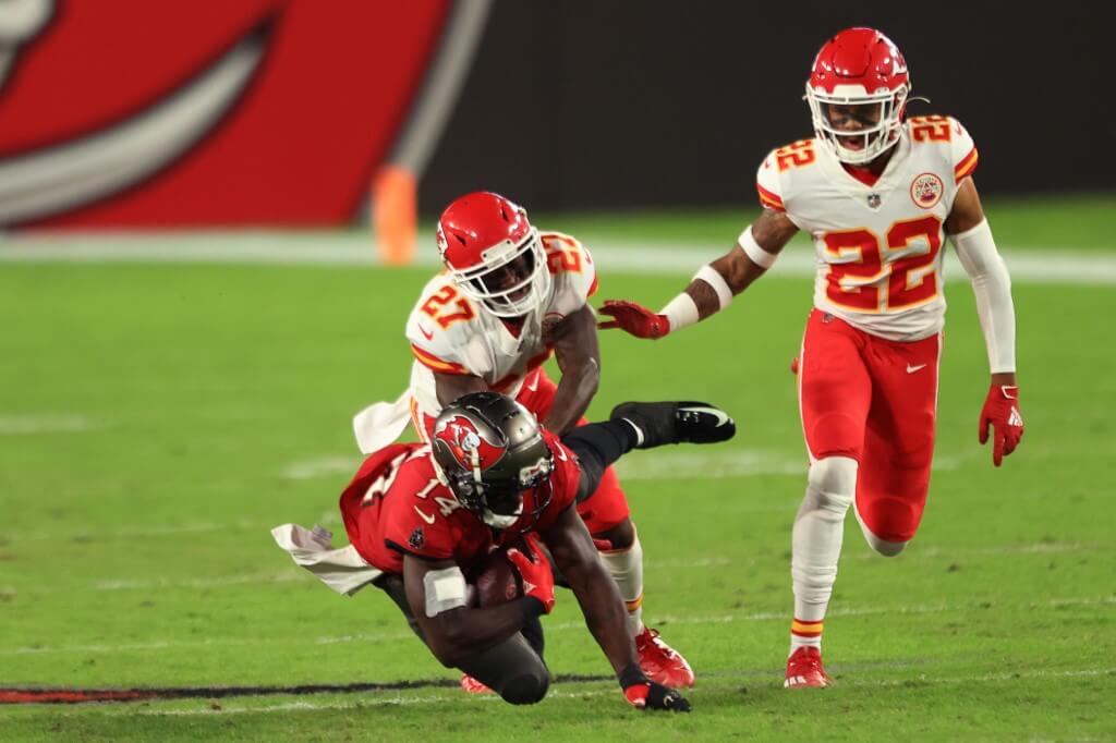 Chris Godwin of the Tampa Bay Buccaneers is tackled by Rashad Fenton and Juan Thornhill of the Kansas City Chiefs