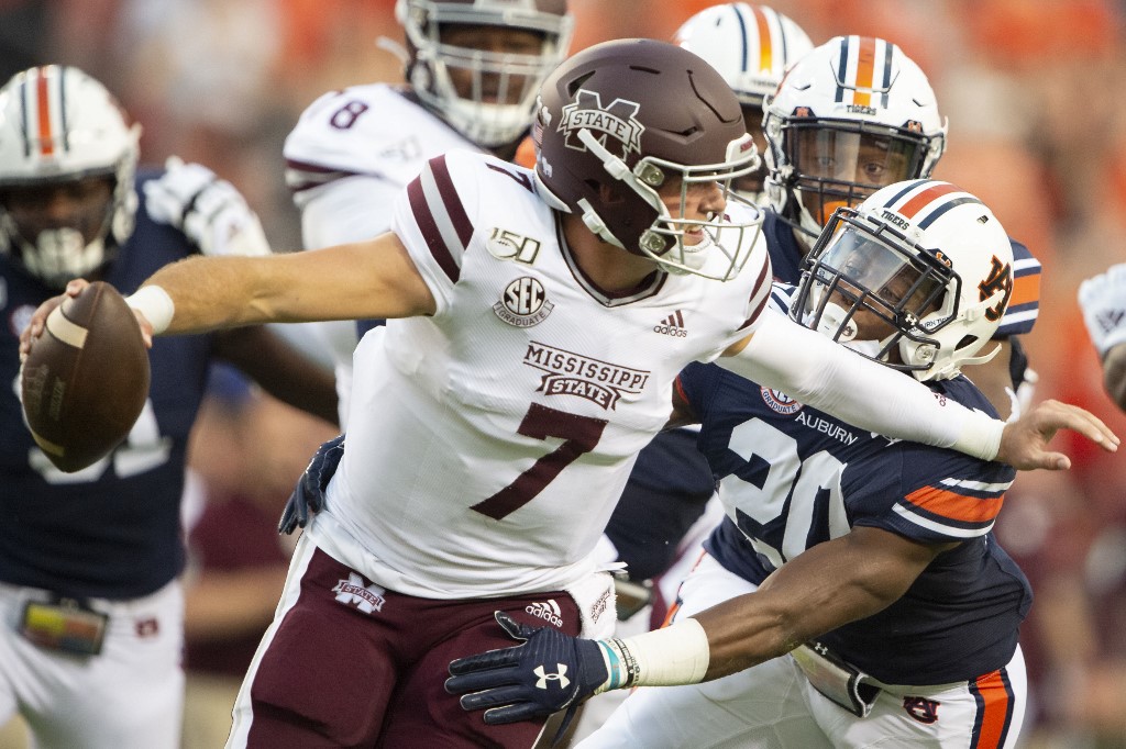 DB Jeremiah Dinson of Auburn Tigers looks to sack QB Tommy Stevens of Mississippi State Bulldogs. More NCAAF Week 15 SEC betting news here.
