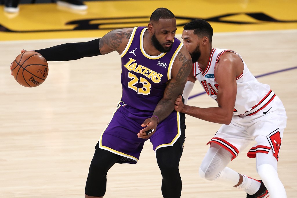 Garrett Temple of the Chicago Bulls defends against the dribble of LeBron James of the Los Angeles Lakers