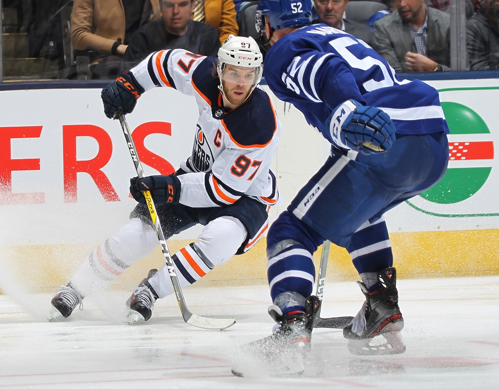 Connor McDavid of the Edmonton Oilers slips away from Martin Marincin #52 of the Toronto Maple Leafs. Here's our NHL betting parlay