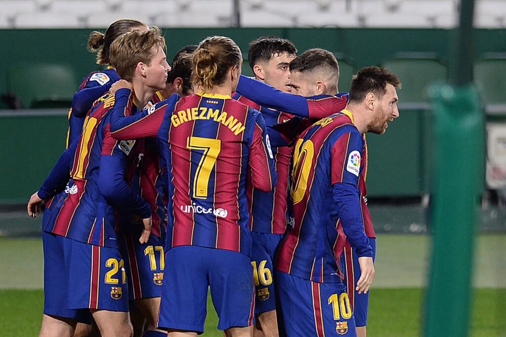 Barcelona's players celebrate their third goal during the Spanish league football match between Real Betis and FC Barcelona