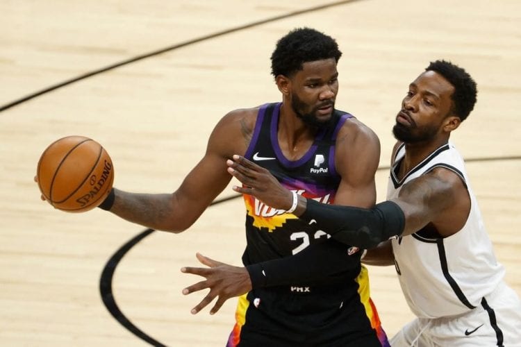 Deandre Ayton of the Phoenix Suns handles the ball against Jeff Green of the Brooklyn Nets during the NBA game