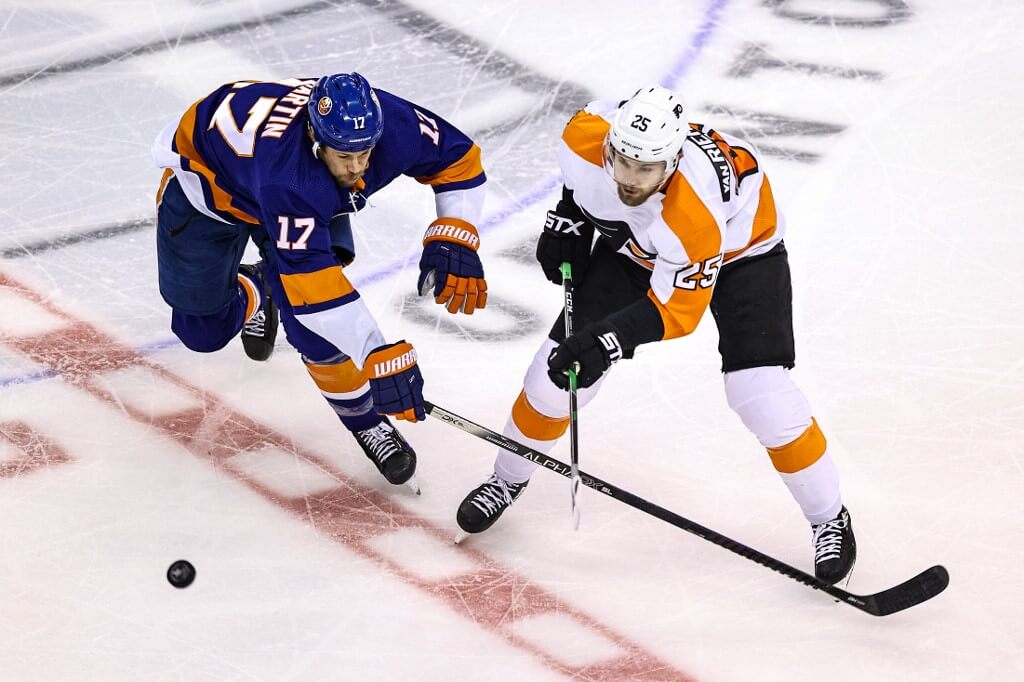 James van Riemsdyk of the Philadelphia Flyers is defended by Matt Martin of the New York Islanders during the second period