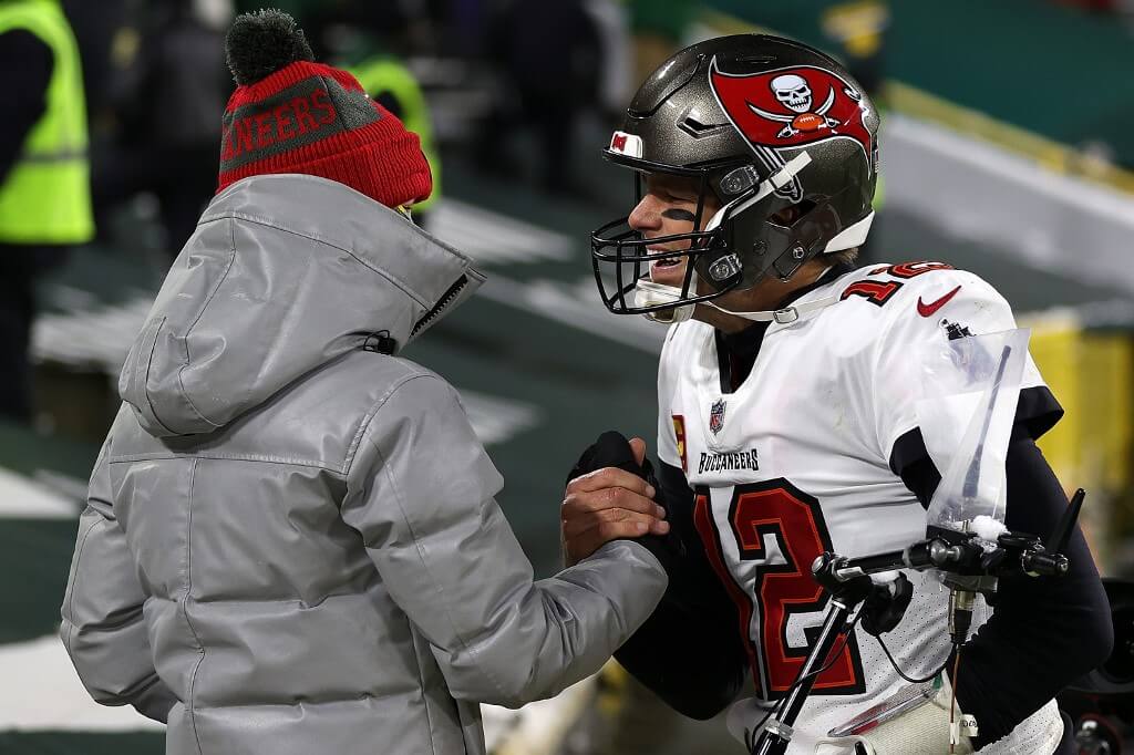 Tom Brady of the Tampa Bay greets his son Jack following their victory over the Green Bay Packers in the NFC Championship