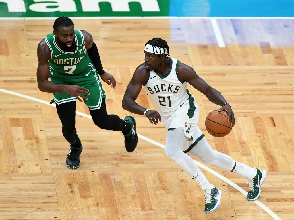 Jrue Holiday #21 of Milwaukee dribbles the ball vs Jaylen Brown #7 of the Boston Celtics. Read our Celtics vs Bucks betting preview.