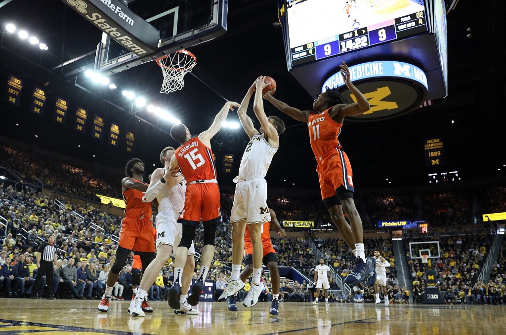 Franz Wagner #21 of the Michigan Wolverines shoots as Ayo Dosunmu defends. Check out our NCAA expert's Illinois vs Michigan prediction.