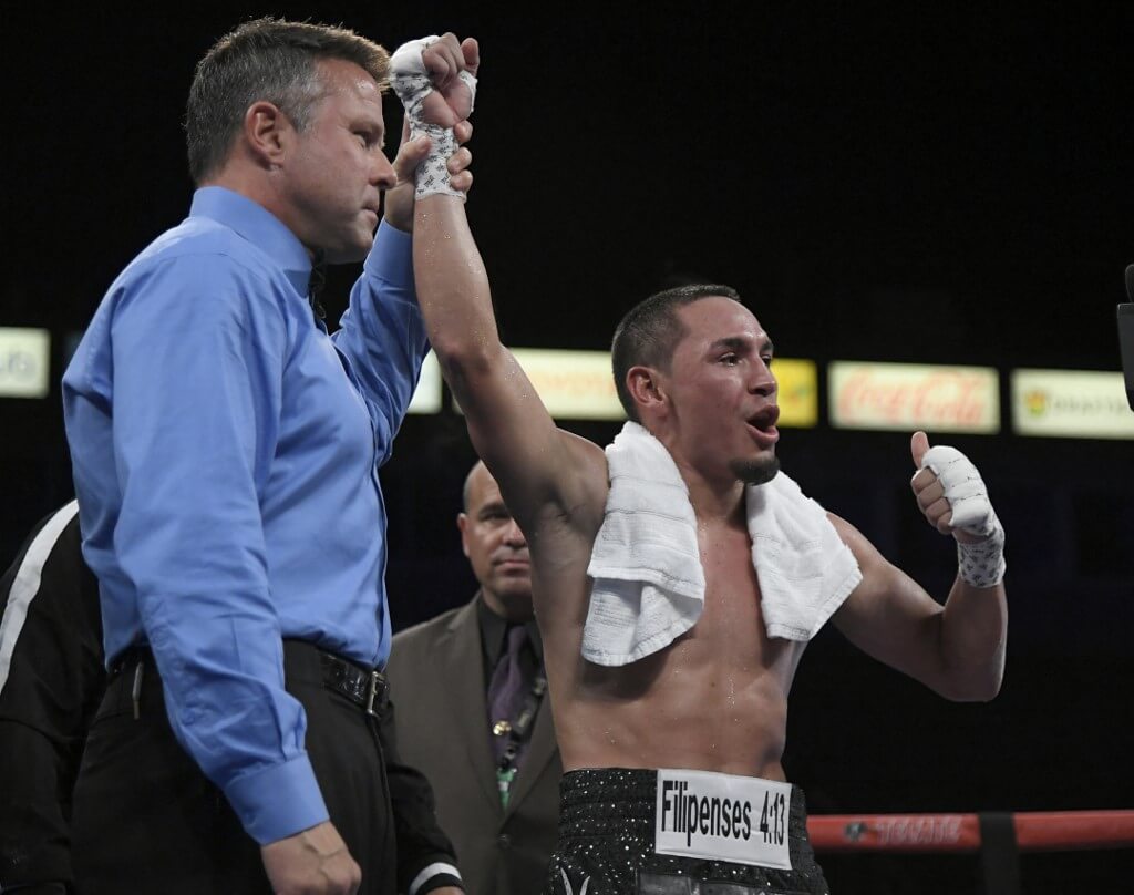 Juan Francisco Estrada has his hand raised in victory after defeating Victor Mendez in seven rounds at StubHub Center