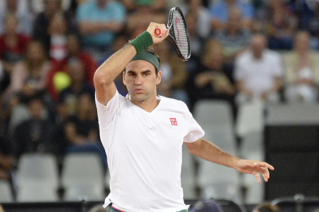 Switzerland's Federer plays a return during a tennis match. Roger Federer returns for the Qatar Open