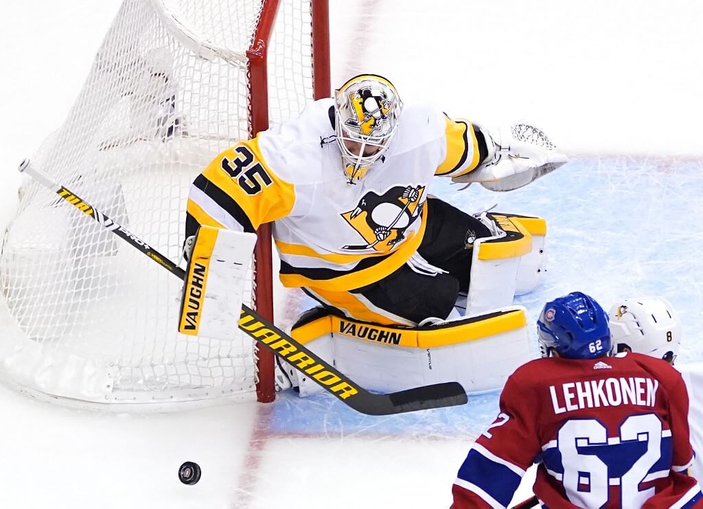Tristan Jarry of the Pittsburgh Penguins deflects a shot by Artturi Lehkonen of the Montreal Canadiens