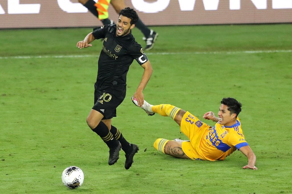 Carlos Salcedo of Tigres UANL fouls Carlos Vela of Los Angeles FC during the CONCACAF Champions League final game