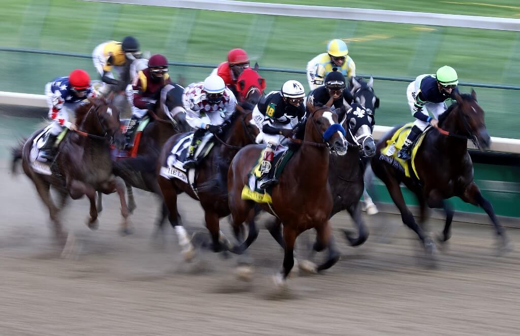 Authentic with John Velazquez aboard leads Tiz The Law and the field down the front stretch