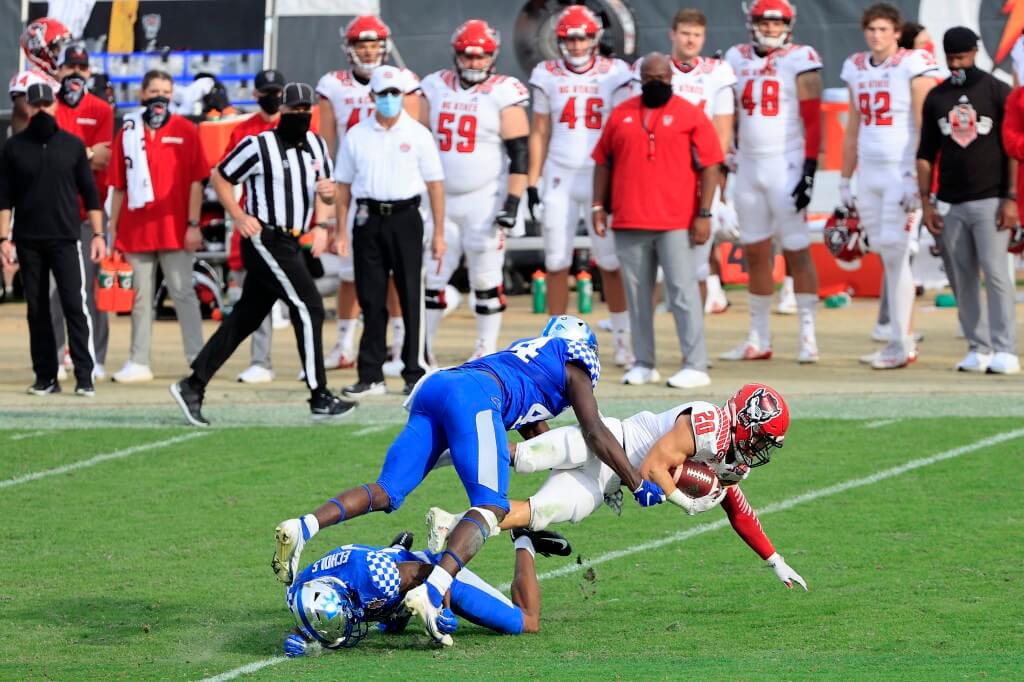 Jordan Houston of the North Carolina State Wolfpack dives for yardage against the Kentucky Wildcats