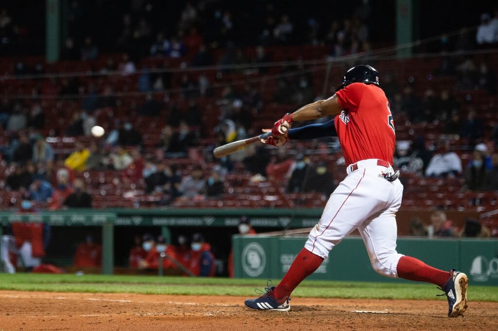 Xander Bogaerts of the Boston Red Sox hits an RBI single in the fifth inning against the Seattle Mariners