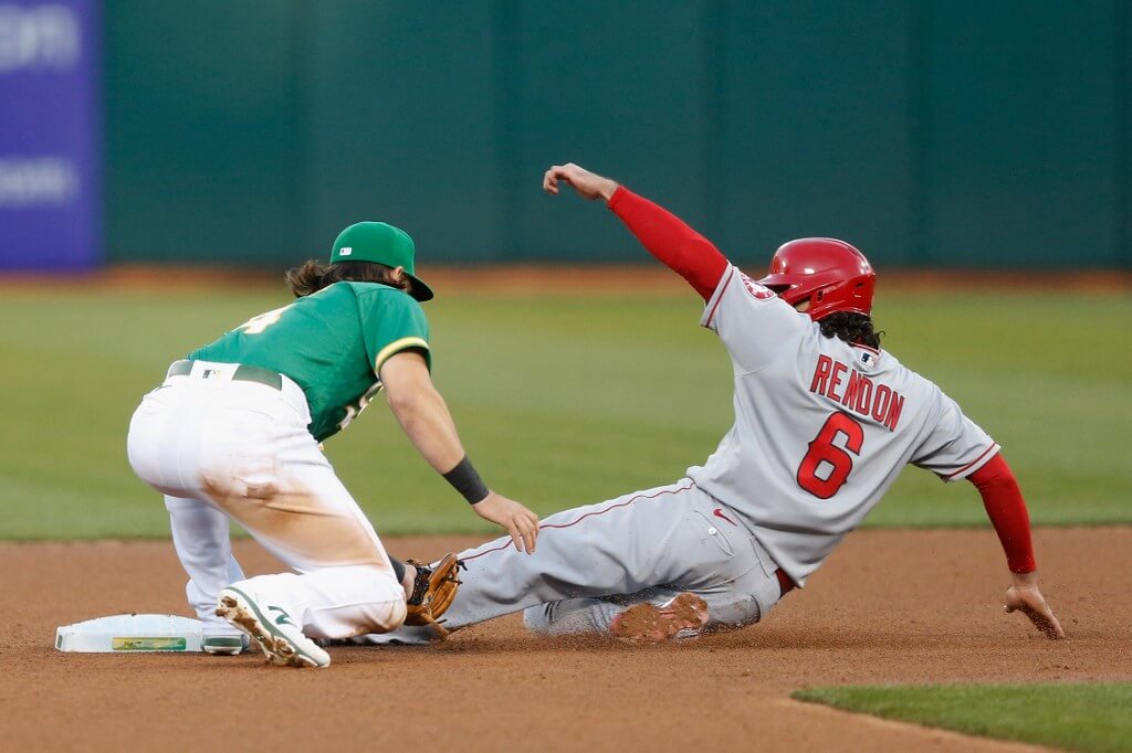 Base runner Anthony Rendon of the Los Angeles Angels is tagged out at second base by Chad Pinder of the Oakland Athletics