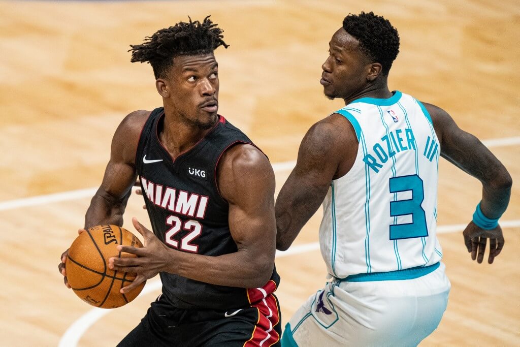 Jimmy Butler of the Miami Heat drives to the basket against Terry Rozier of the Charlotte Hornets