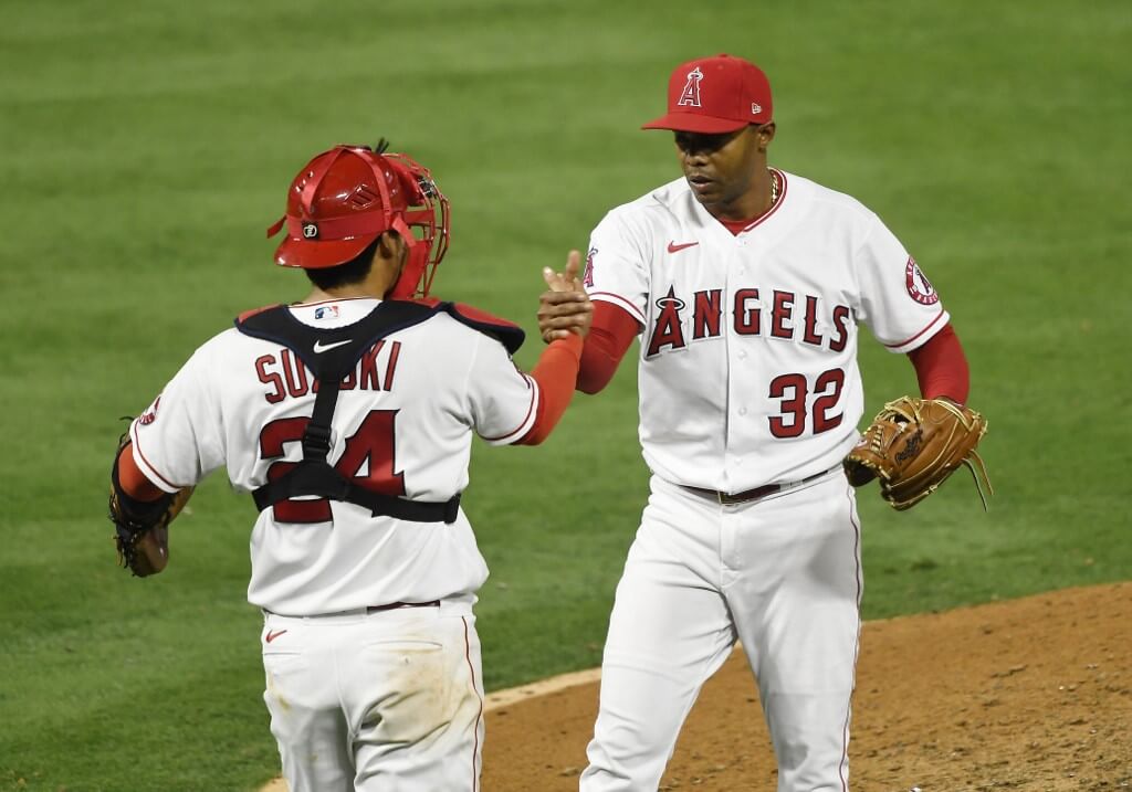Relief pitcher Raisel Iglesias of the Los Angeles Angels celebrates with catcher Kurt Suzuki