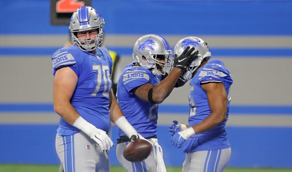 Adrian Peterson of the Detroit Lions celebrates with teammates after scoring a touchdown against the Minnesota Vikings