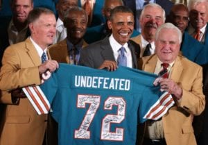 Barack Obama poses for photos with members of the 1972 Miami Dolphins including head coach Don Shula, Bob Griese,Larry Csonka