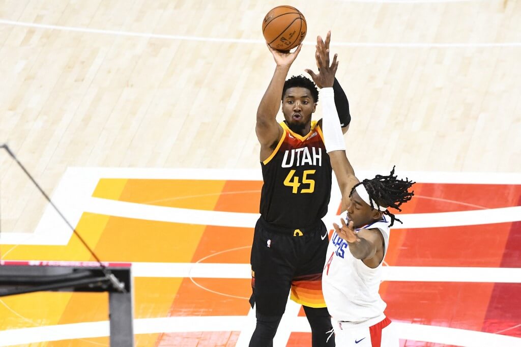 Donovan Mitchell of the Utah Jazz shoots over Terance Mann of the LA Clippers