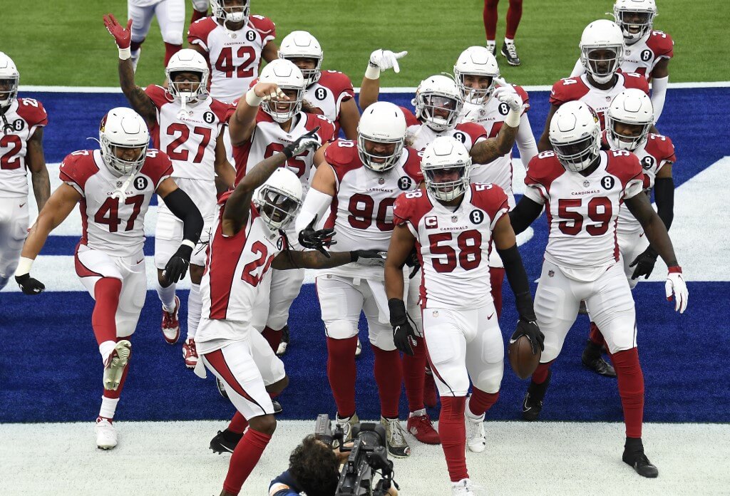 Jordan Hicks of the Arizona Cardinals celebrates with teammates after intercepting a pass against the Los Angeles Rams