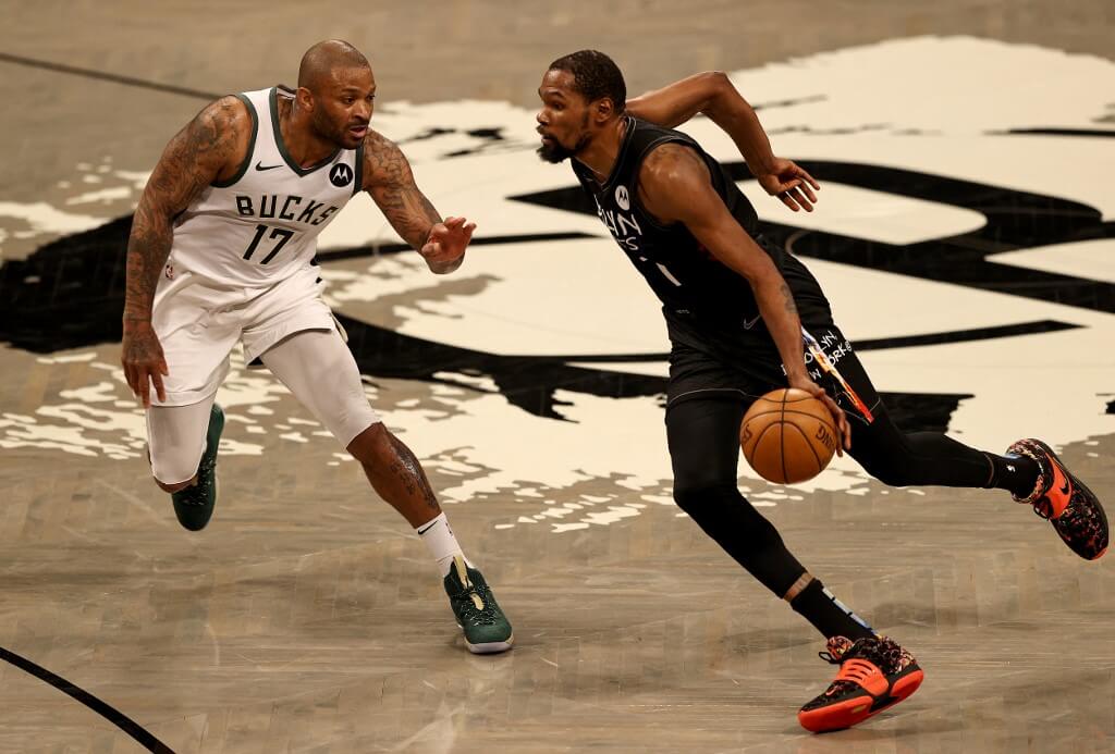 Kevin Durant of the Brooklyn Nets drives past P.J. Tucker of the Milwaukee Bucks