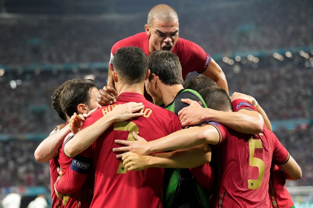 Portugal's forward Cristiano Ronaldo celebrates with teammates after scoring a penalty kick against Portugal and France