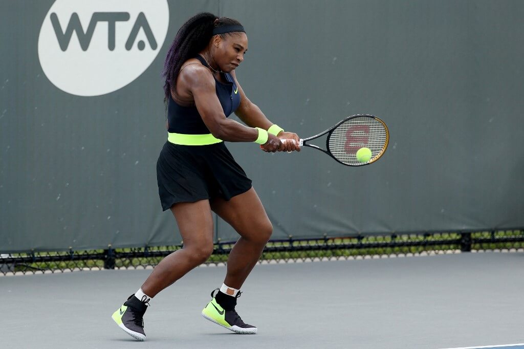 Serena Williams plays a backhand during her match against Venus Williams during Top Seed Open