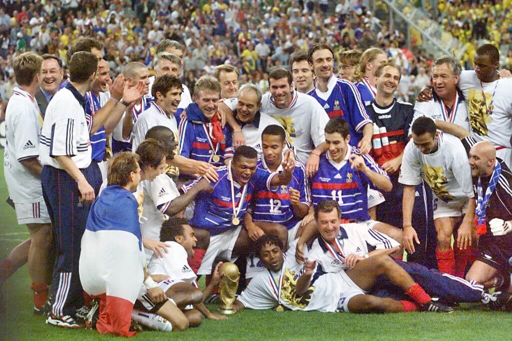 The French team celebrates with the FIFA trophy after France defeated Brazil 3-0 in the 1998 World Cup final