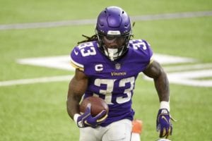 Dalvin Cook of the Minnesota Vikings runs with the ball as Eddie Jackson of the Chicago Bears