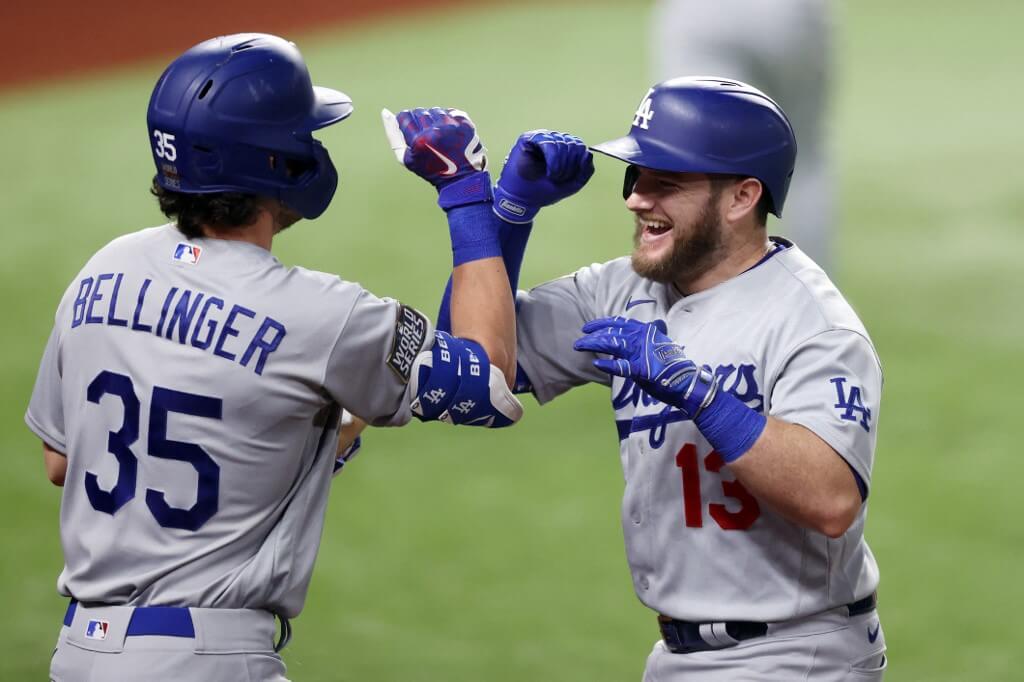 Max Muncy of the Los Angeles Dodgers is congratulated by Cody Bellinger after hitting a solo home run