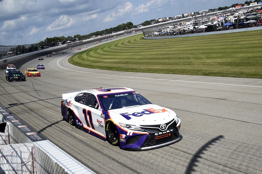 Denny Hamlin leads the field during the NASCAR Cup Series FireKeepers Casino 400