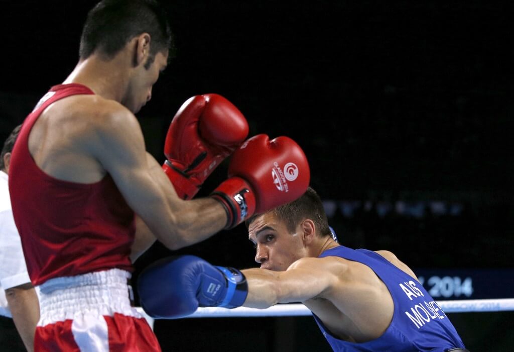 Pakistan's Muhammad Waseem fights Australia's Andrew Moloney during the men's fly final boxing