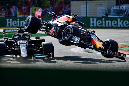 British driver Lewis Hamilton (L) and Red Bull's Dutch driver Max Verstappen collide during the Italian Formula One Grand Prix (Photo by ANDREJ ISAKOVIC / AFP)
