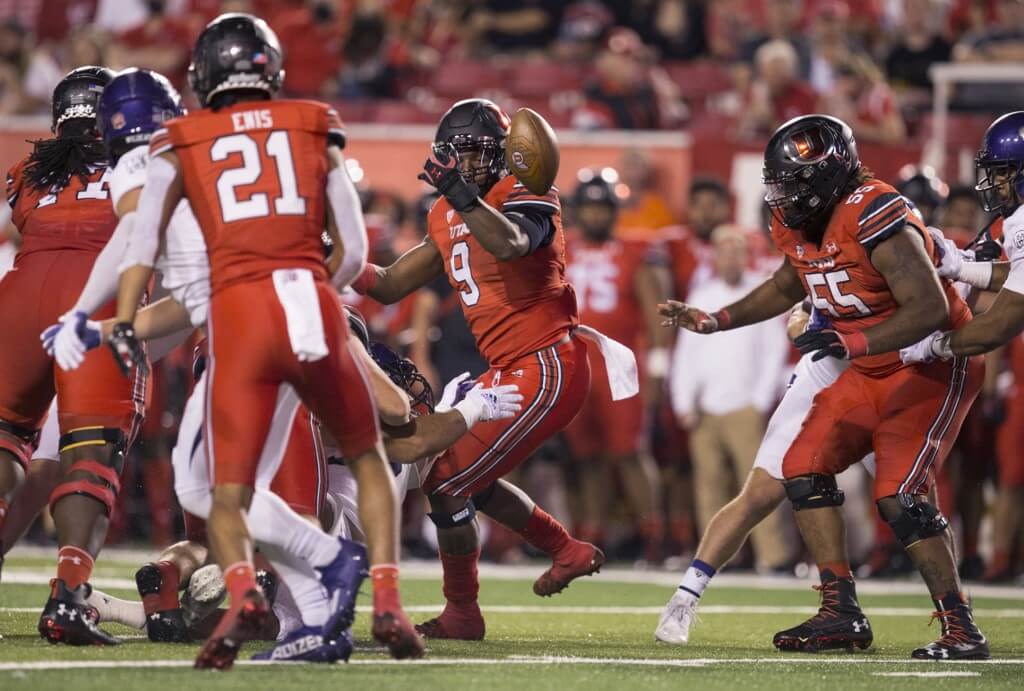 Tavion Thomas of the University of Utah Utes fumbles as he rushes against the Weber State Wildcats