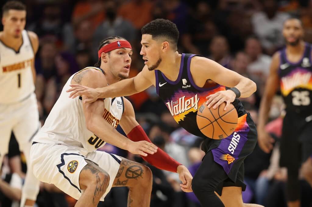 Devin Booker handles the ball Denver Nuggets vs Phoenix Suns Picks