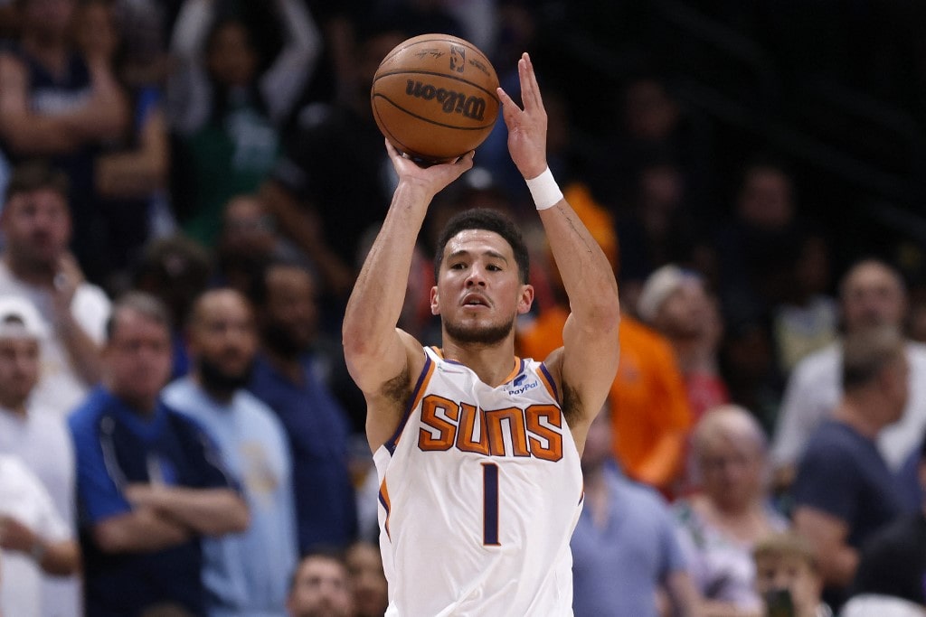 Devin Booker #1 of the Phoenix Suns shoots the ball against Dwight Powell #7 of the Dallas Mavericks in the second quarter of Game Six of the 2022 NBA Playoffs Western Conference Semifinals