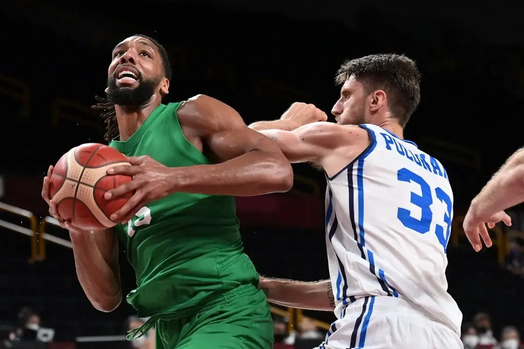 Nigeria's Jahlil Okafor goes to the basket past Italy's Achille Polonara (R)