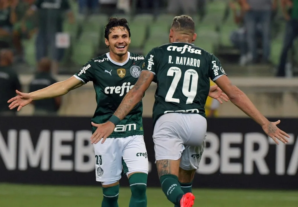 Brazil's Palmeiras Raphael Veiga (L) celebrates after scoring against Bolivia's Independiente Petrolero during the Copa Libertadores.