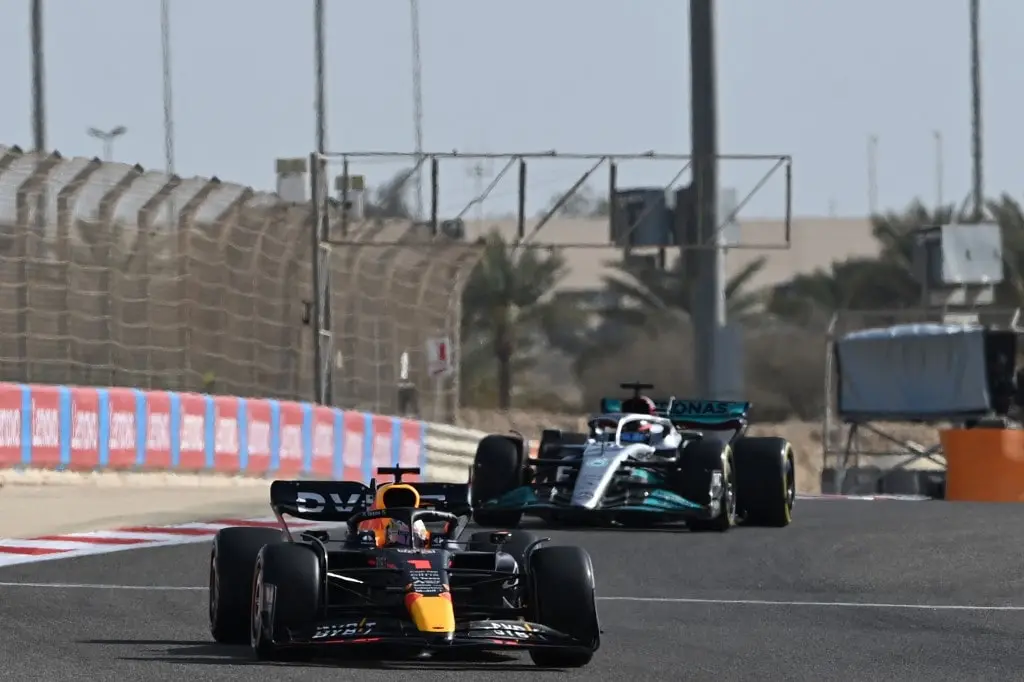 Red Bull's Dutch driver Max Verstappen, followed by Mercedes' British driver Lewis Hamilton, drive during the first practice session ahead of the Bahrain Formula One Grand Prix at the Bahrain International Circuit in the city of Sakhir on March 18, 2022.