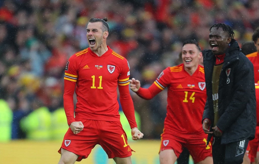 Wales' striker Gareth Bale (L) celebrates with teammates after winning the FIFA World Cup 2022