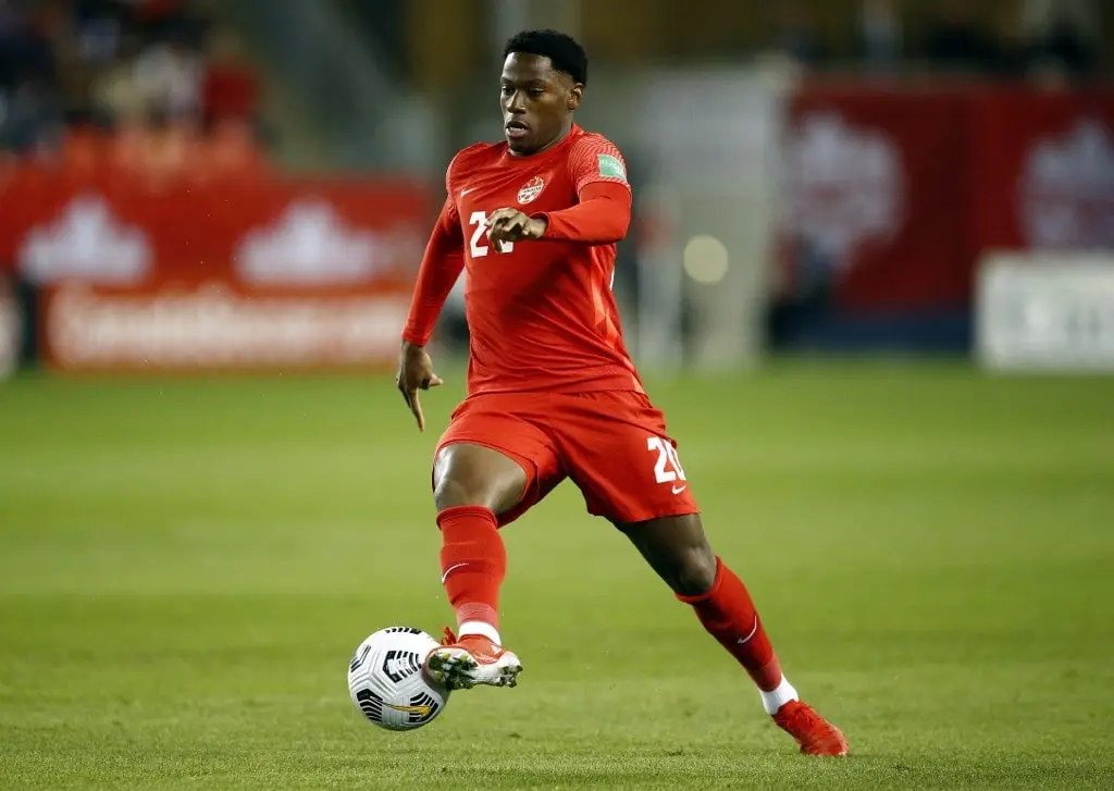 Jonathan David #20 of Canada dribbles the ball during a 2022 World Cup Qualifying match against Honduras at BMO Field on September 2