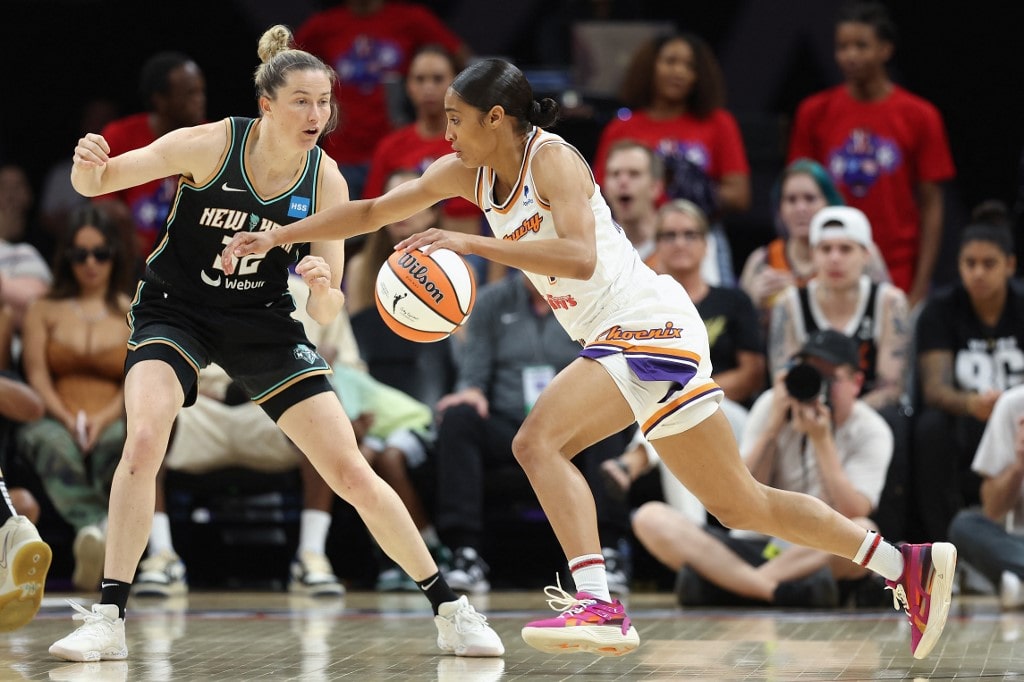 Skylar Diggins-Smith #4 of the Phoenix Mercury handles the ball against Sami Whitcomb #32 of the New York Liberty during the WNBA game at Footprint Center