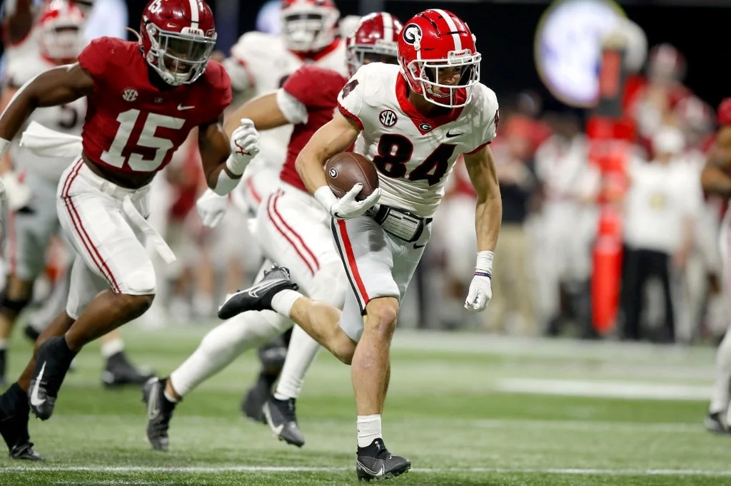Ladd McConkey #84 of the Georgia Bulldogs runs with the ball for a touchdown in the second quarter of the SEC Championship game against the Alabama Crimson Tide