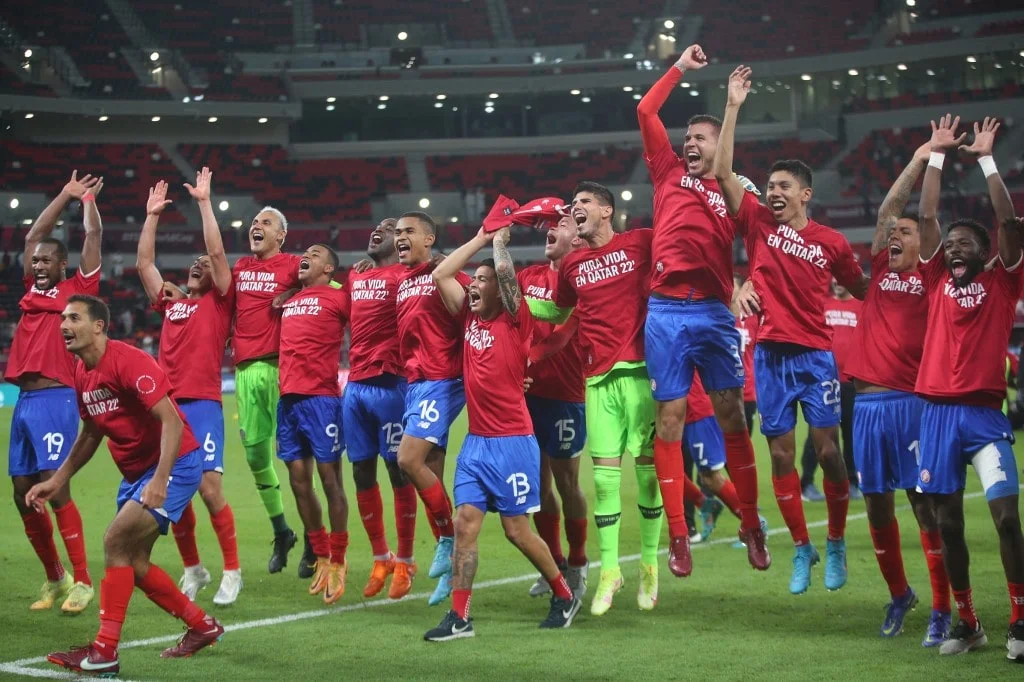 Costa Rica's players celebrate their win in the FIFA World Cup 2022 inter-confederation play-offs match