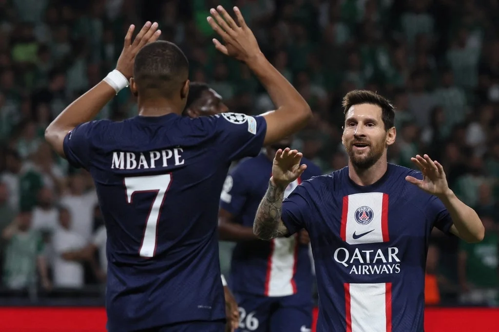 PSG's Lionel Messi celebrates with PSG's Kylian Mbappe